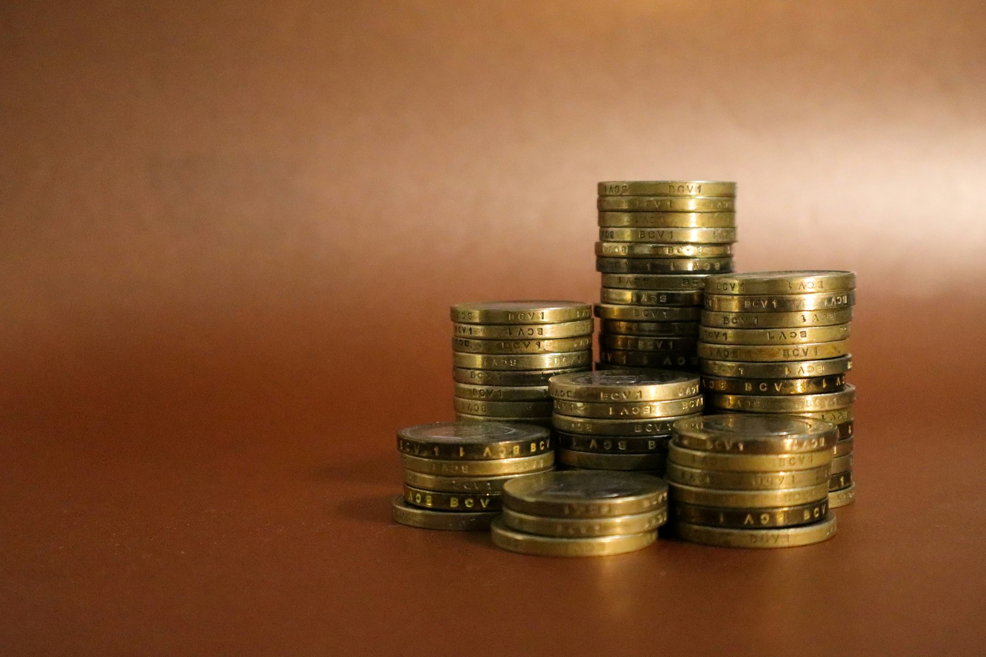 A pile of gold coins sitting on top of a table